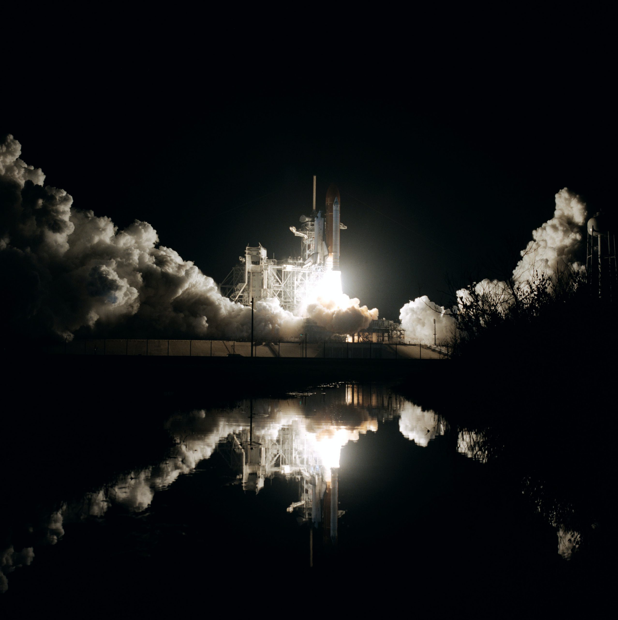 space shuttle launch and rocket explosion at night